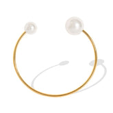 Perla bracelet styled beside neutral-toned accessories and silk pouch